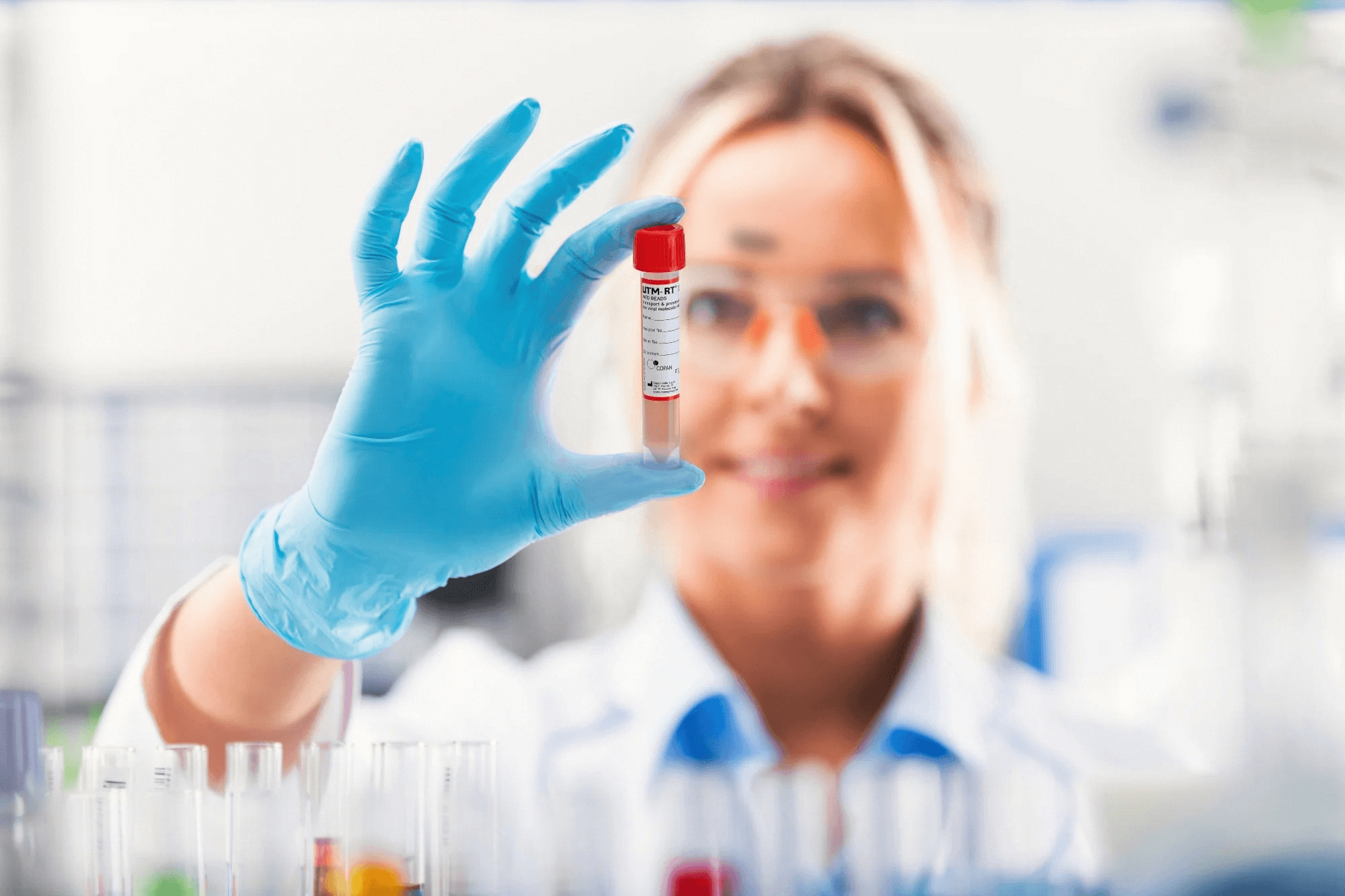 Laboratory professional holding a UTM tube