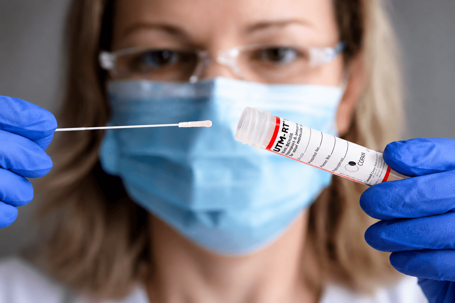 Laboratory professional holding a UTM-RT® transport tube